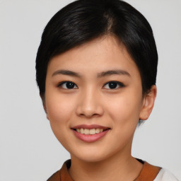 Joyful asian young-adult female with short  black hair and brown eyes