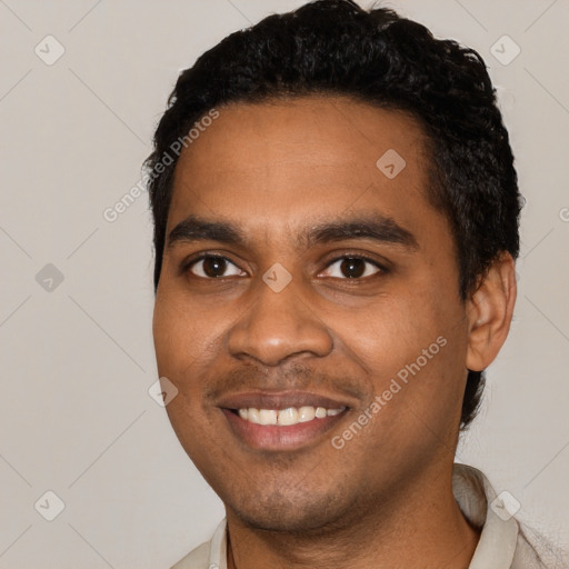 Joyful black young-adult male with short  black hair and brown eyes