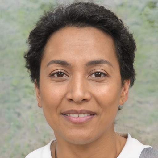 Joyful latino adult female with short  brown hair and brown eyes