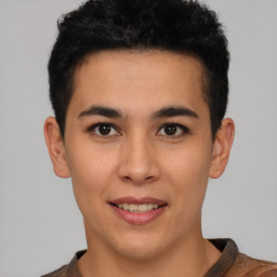 Joyful latino young-adult male with short  brown hair and brown eyes