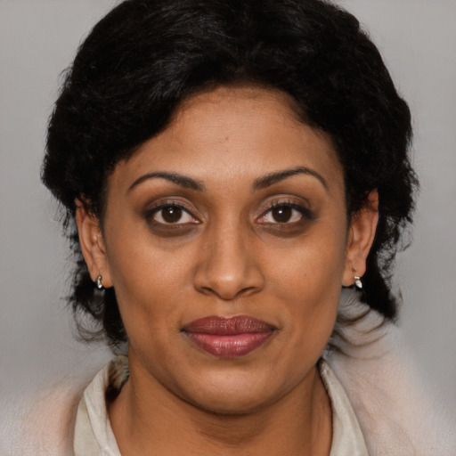 Joyful black adult female with short  brown hair and brown eyes