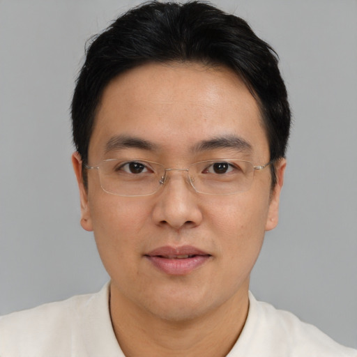 Joyful asian adult male with short  brown hair and brown eyes