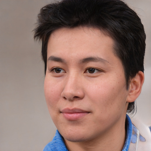 Joyful asian young-adult male with medium  brown hair and brown eyes