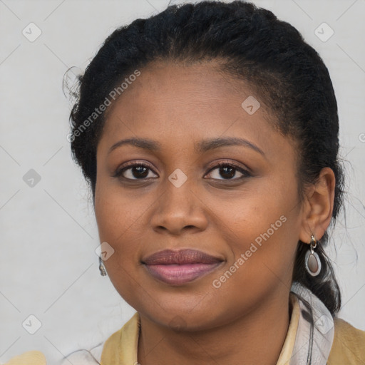 Joyful black young-adult female with long  brown hair and brown eyes