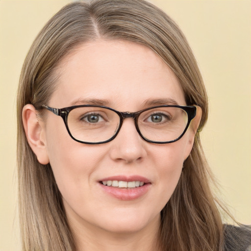 Joyful white young-adult female with long  brown hair and blue eyes