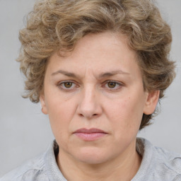 Joyful white adult female with medium  brown hair and blue eyes