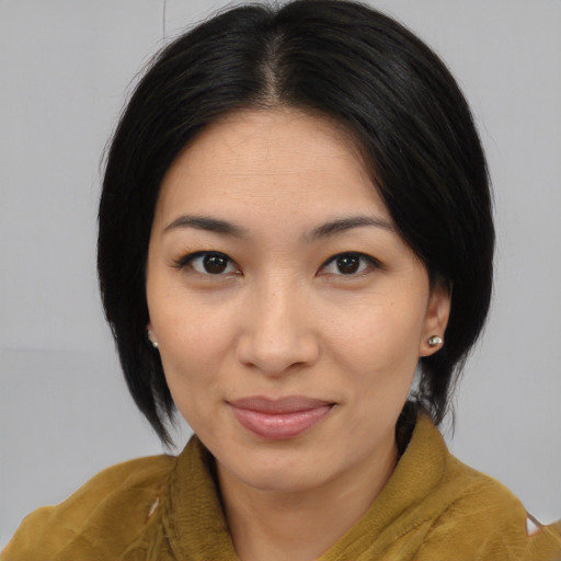 Joyful latino young-adult female with medium  black hair and brown eyes