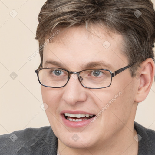 Joyful white adult male with short  brown hair and brown eyes