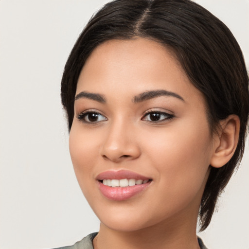 Joyful white young-adult female with long  brown hair and brown eyes