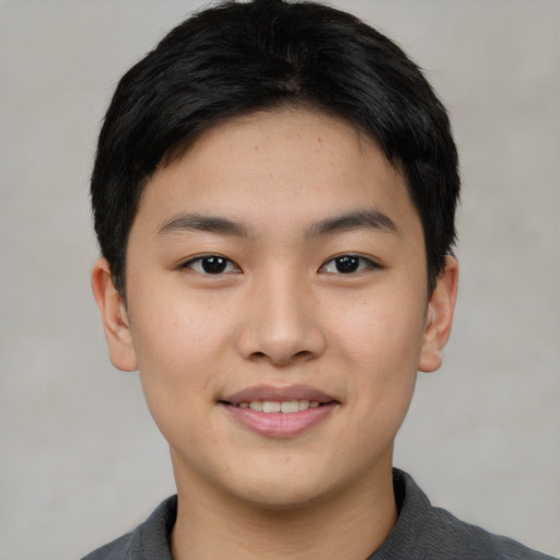 Joyful asian young-adult male with short  black hair and brown eyes