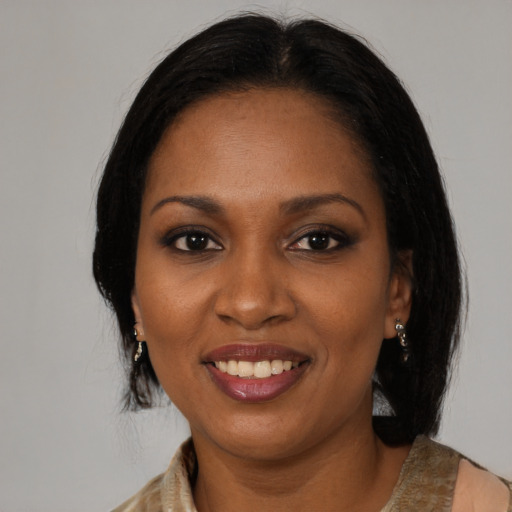 Joyful black young-adult female with medium  brown hair and brown eyes
