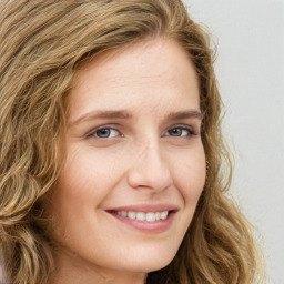 Joyful white young-adult female with long  brown hair and green eyes