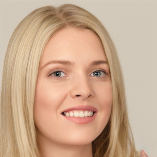 Joyful white young-adult female with long  blond hair and blue eyes