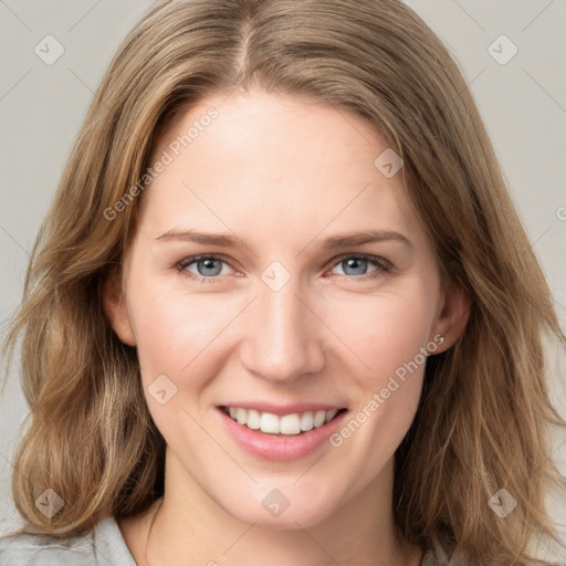 Joyful white young-adult female with long  brown hair and blue eyes