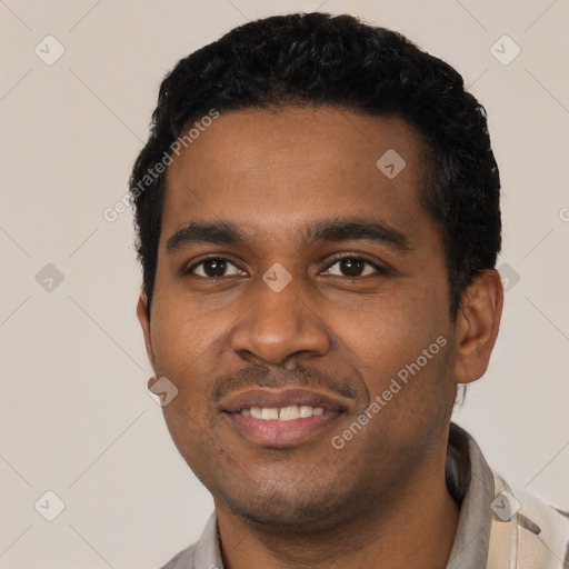 Joyful black young-adult male with short  black hair and brown eyes