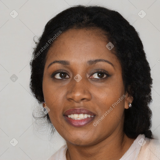 Joyful black adult female with medium  brown hair and brown eyes