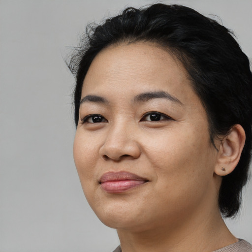 Joyful asian young-adult female with medium  black hair and brown eyes