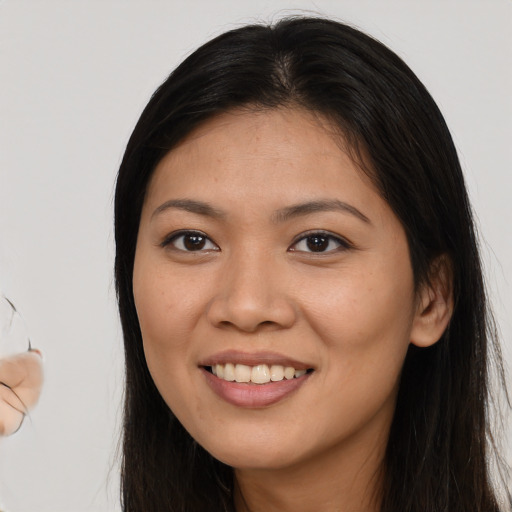 Joyful asian young-adult female with long  brown hair and brown eyes