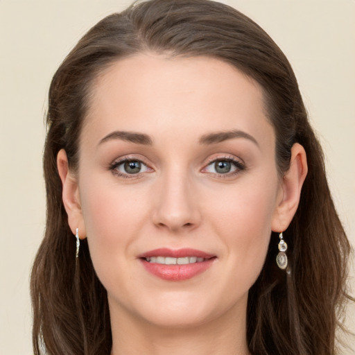 Joyful white young-adult female with long  brown hair and grey eyes