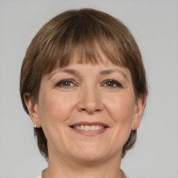 Joyful white adult female with medium  brown hair and grey eyes