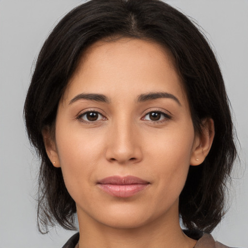 Joyful white young-adult female with medium  brown hair and brown eyes