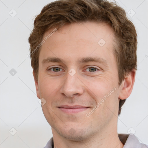 Joyful white adult male with short  brown hair and grey eyes