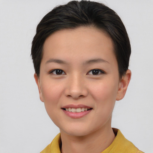 Joyful asian young-adult female with short  brown hair and brown eyes