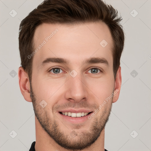 Joyful white young-adult male with short  brown hair and grey eyes