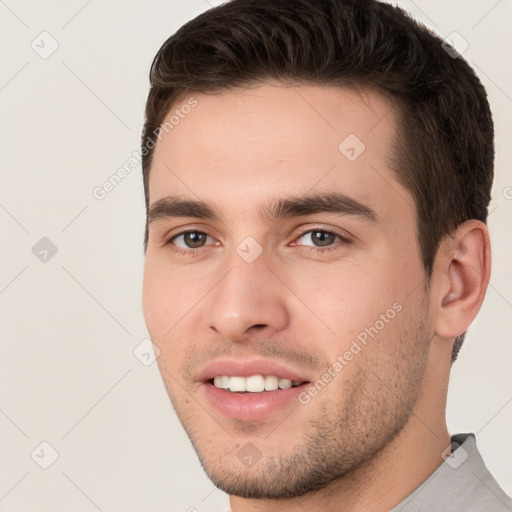 Joyful white young-adult male with short  brown hair and brown eyes