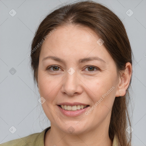 Joyful white adult female with medium  brown hair and grey eyes