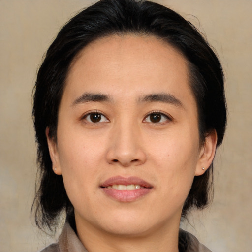Joyful white young-adult female with medium  black hair and brown eyes