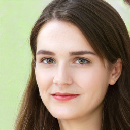 Joyful white young-adult female with long  brown hair and green eyes