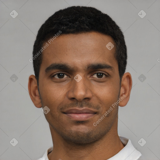 Joyful black young-adult male with short  brown hair and brown eyes