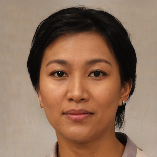 Neutral asian adult female with medium  black hair and brown eyes