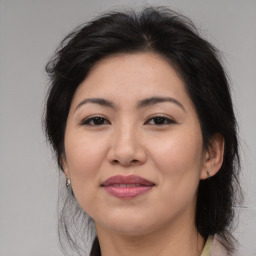 Joyful asian adult female with medium  brown hair and brown eyes