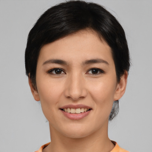 Joyful asian young-adult female with short  black hair and brown eyes