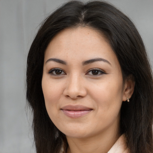 Joyful asian young-adult female with long  brown hair and brown eyes