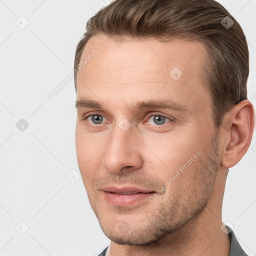 Joyful white adult male with short  brown hair and brown eyes