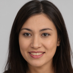 Joyful white young-adult female with long  brown hair and brown eyes