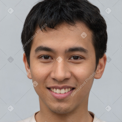 Joyful latino young-adult male with short  brown hair and brown eyes