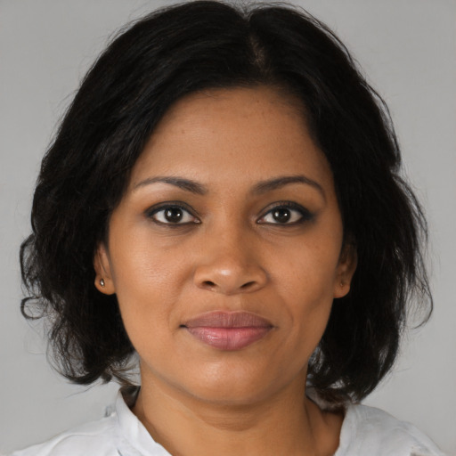 Joyful black young-adult female with medium  brown hair and brown eyes