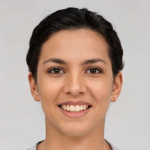 Joyful latino young-adult female with short  brown hair and brown eyes