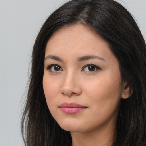 Joyful asian young-adult female with long  brown hair and brown eyes