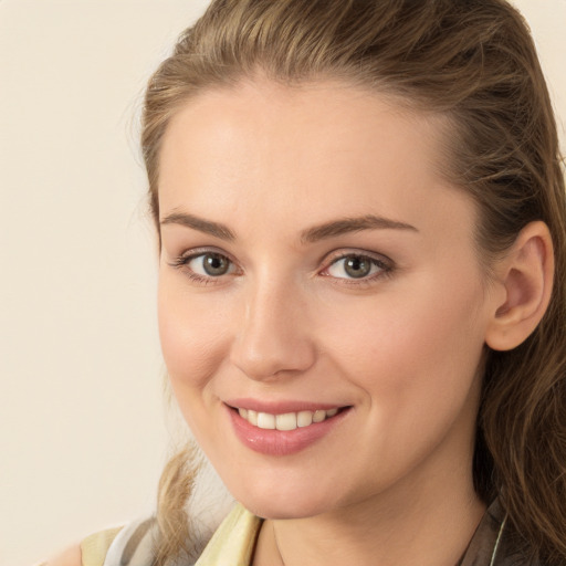 Joyful white young-adult female with long  brown hair and brown eyes