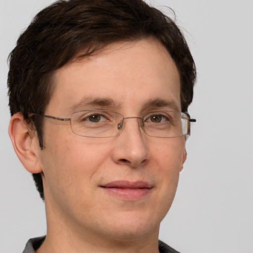 Joyful white adult male with short  brown hair and grey eyes