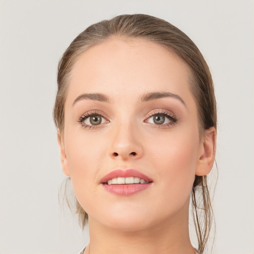 Joyful white young-adult female with medium  brown hair and grey eyes