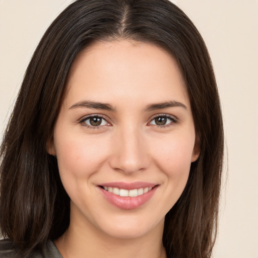 Joyful white young-adult female with long  brown hair and brown eyes