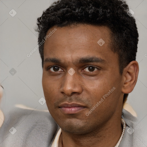 Neutral black young-adult male with short  black hair and brown eyes