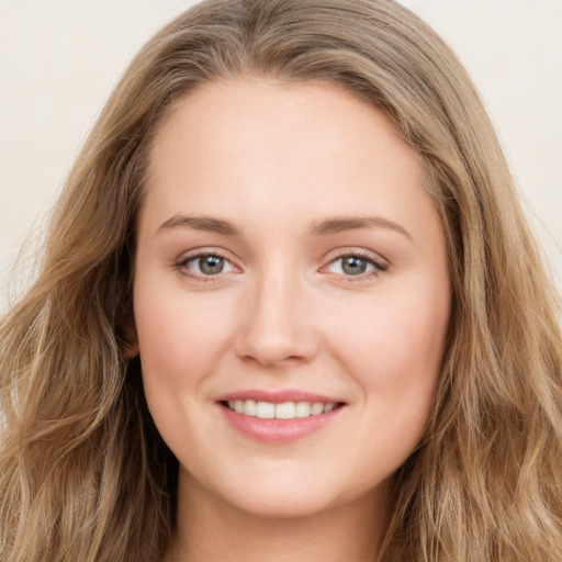 Joyful white young-adult female with long  brown hair and green eyes