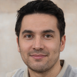 Joyful white young-adult male with short  black hair and brown eyes